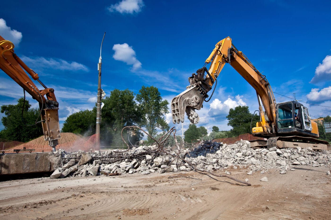 building being demolished by an excavator